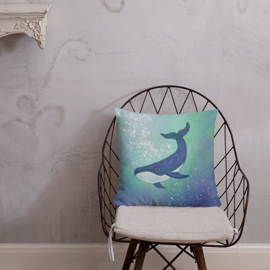 Decorative pillow with a whale design on a chair against a wall. A guide through time, holding stories older than language.