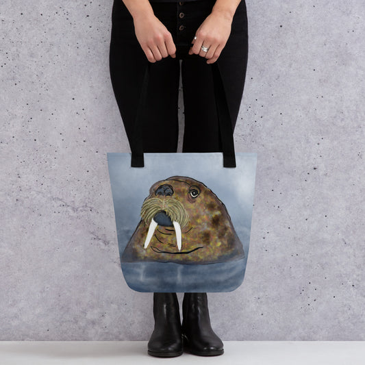 Walrus  on blue hardcover notebook/journal. Gentle giant, spirit guide, medicine man. Close up of Walrus head popping out of the sea. Product mockup shown a held by a woman dressed in black.