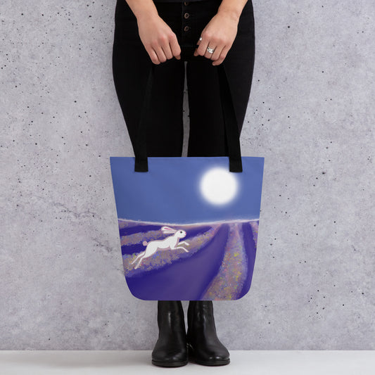 Carry the magical spirit of the hare or rabbit with you. A spacious and colorful tote bag to help you carry around everything that matters. Design shows hare running through a field under a full moon. Blues, purples and white.