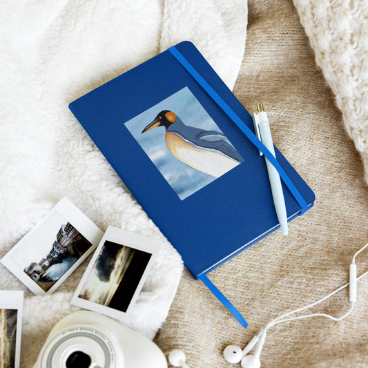 Writing notebook with image of Emperor Penguin spirit guide. Perfect for bullet journaling. Blue cover, elastic closure, and ribbon bookmark.