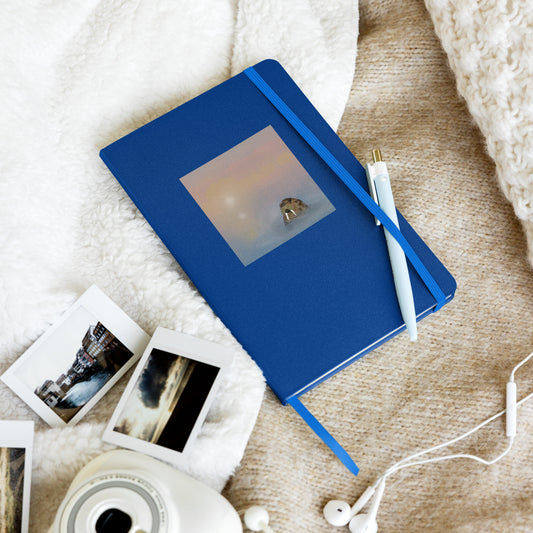 Walrus  on blue hardcover notebook/journal. Gentle giant, spirit guide, medicine man. Walrus head popping out of the misty arctic sea. Product mockup shown on blanket with pen held in elastic enclosure.
