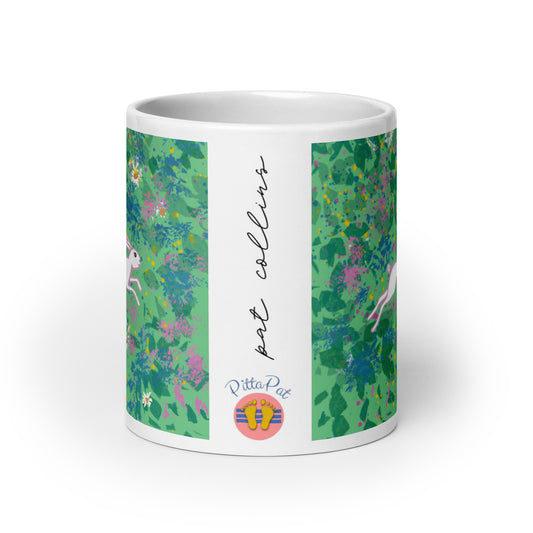 PittaPat happy feet logo with artist's signature on side of Spring Hare mug.
