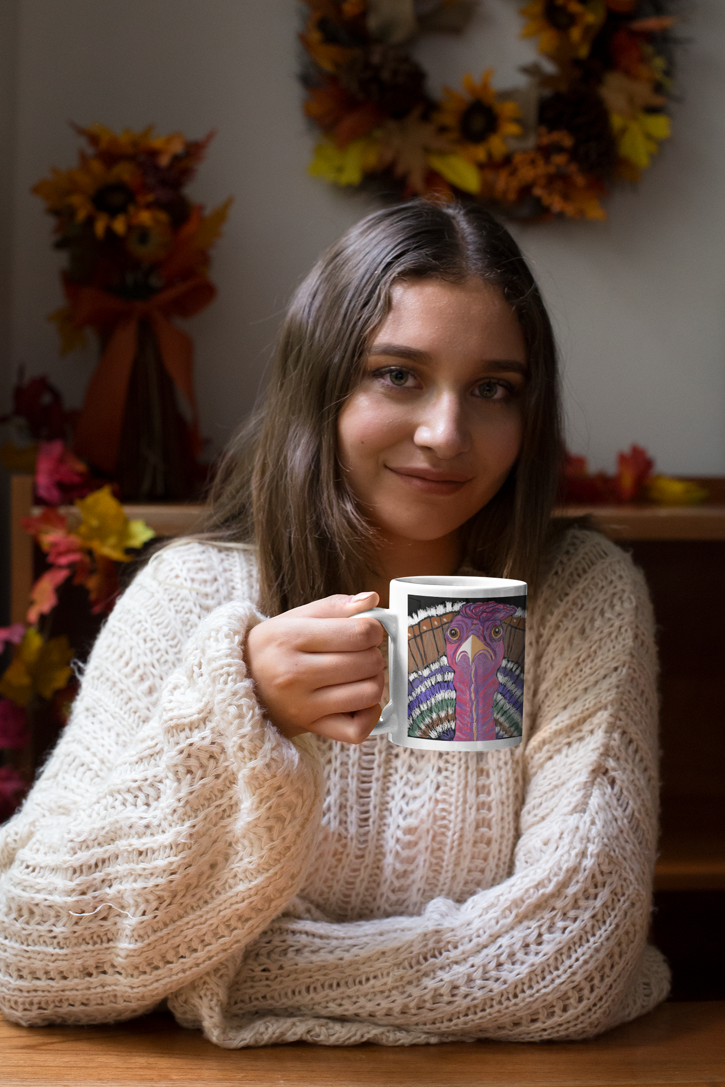 Woman holding a mug with a Turkey design in a cozy indoor autumn setting.