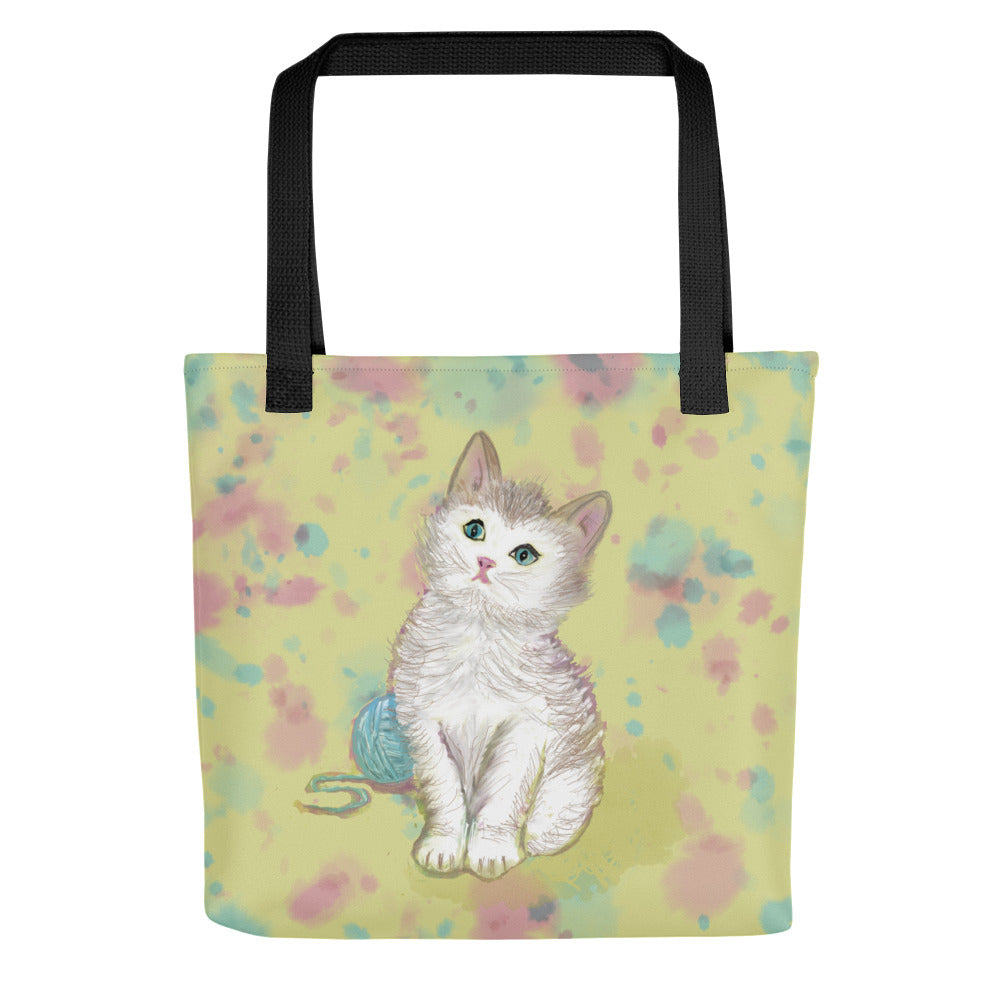 Sweet and sturdy tote bag. A white and tan kitten sits in front of a blue ball of yarn.  Original artwork in soft yellow, blues, and pinks.