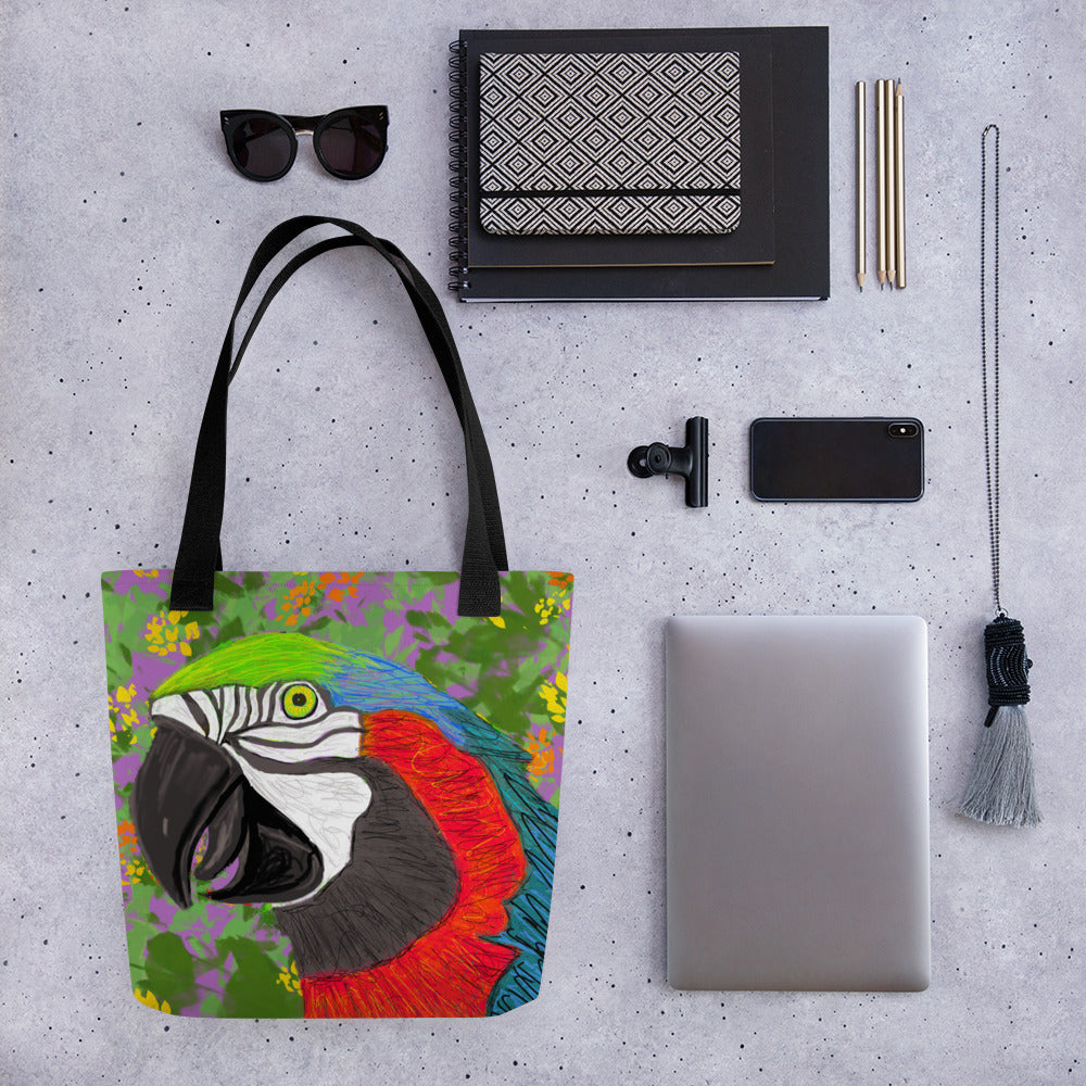 Bold parrot design on a tote bag shown in the wild with bright colors, reds, blues, greens, purples, orange and yellow. Large enough to hold laptops and notebooks and all the necessities for a trip to the office or the coffee shop.