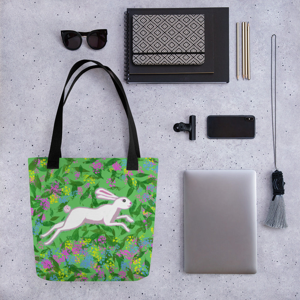 Cheerful totebag with a soft, whimsical design in of a running hare in green, white, pinks and yellow. Large enough to hold laptops and notebooks and all the necessities for a trip to the office or the coffee shop.