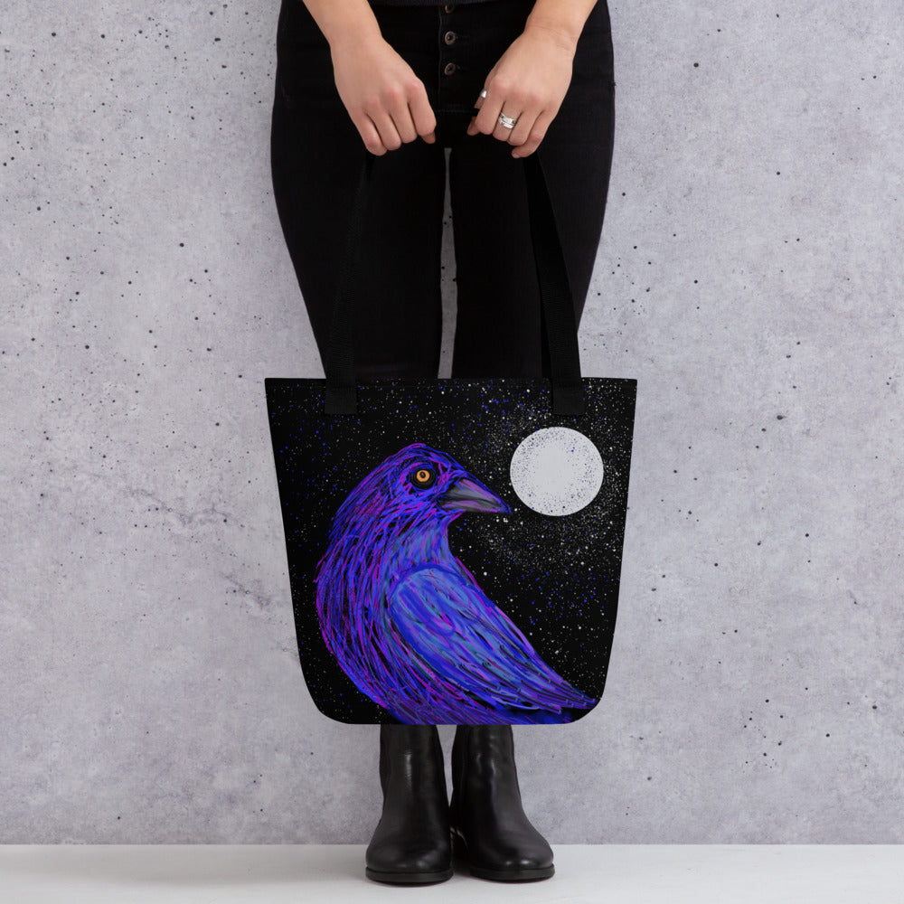 A dramatic tote bag to carry from office to the beach. Image of a crow in the moonlight rendered in black, blue, and purple. Spirit animal of mystery and transformation.