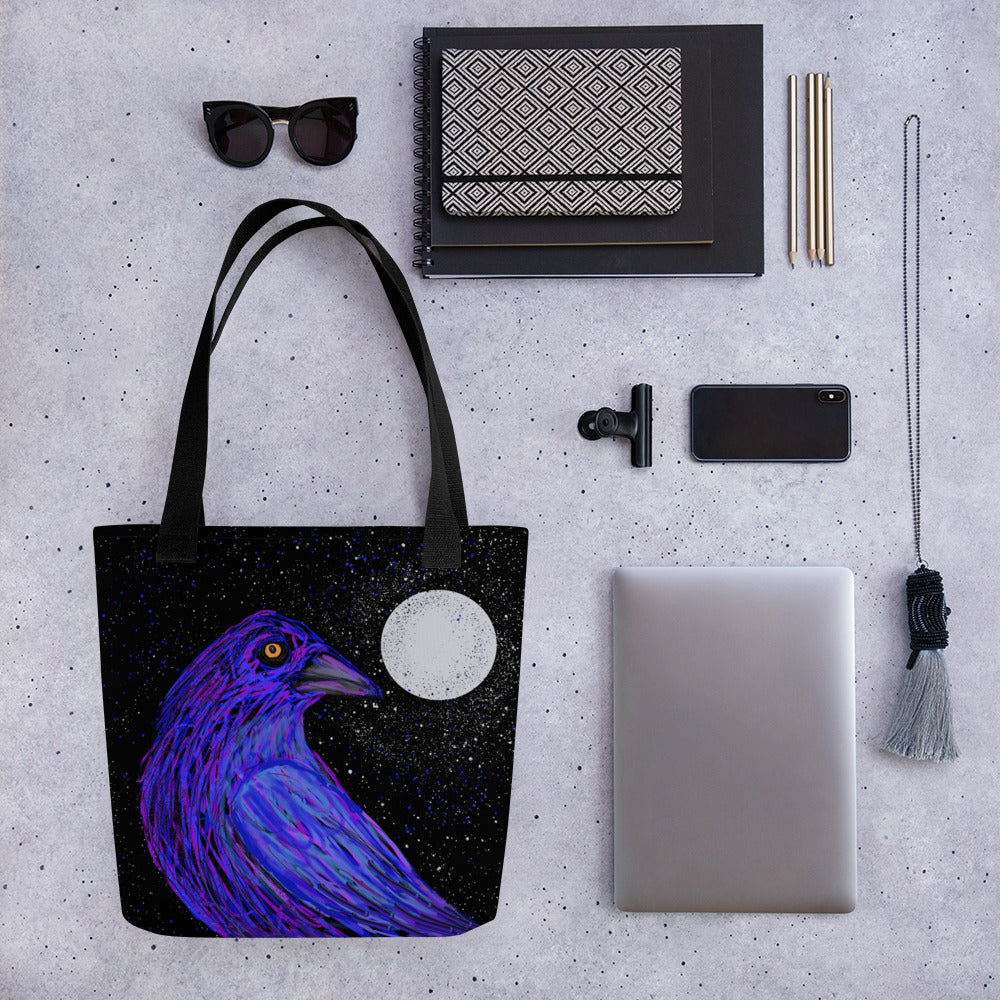 Stylish totebag with a dramatic design in black, blues, purples and white. Image of a crow in the moonlight, your spirit guide for mystery and transformation. To hold laptops and notebooks and all the necessities for a trip to the office or the coffee shop.