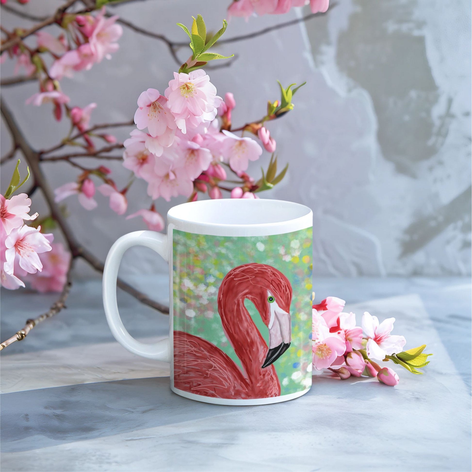 Flamingo spirit mug on a table with cherry blossoms