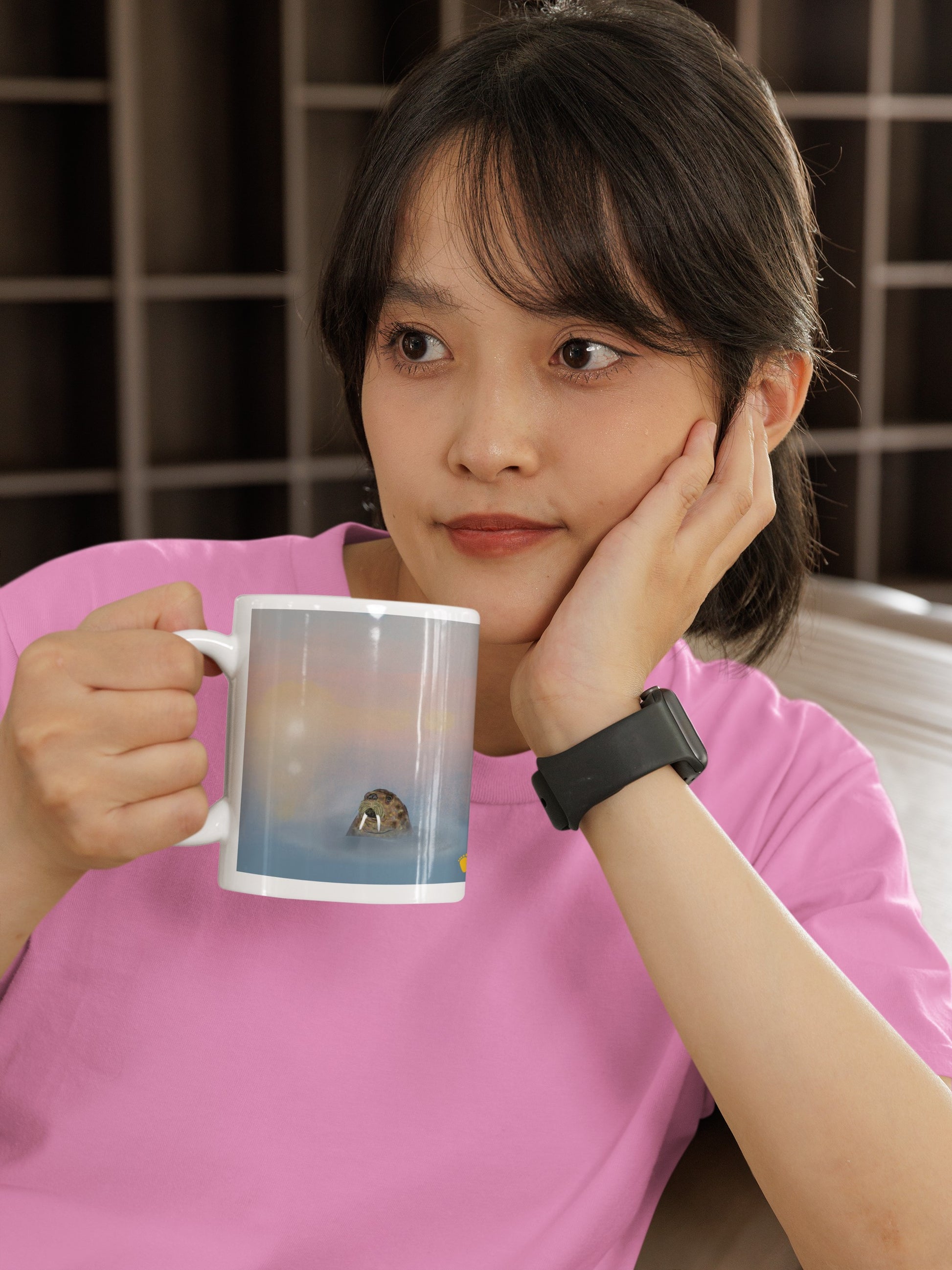 Walrus  ceramic coffee mug, 20 oz. Gentle giant, spirit guide, medicine man. Walrus head popping out of the misty arctic sea. Product mockup shown held by Asian woman in pink shirt.