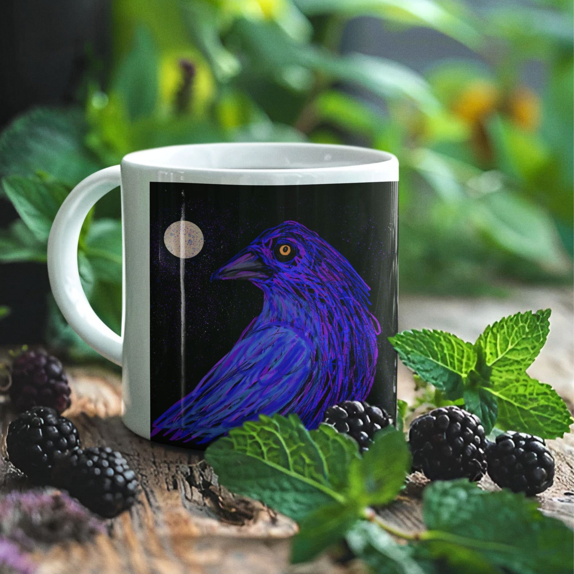 Ceramic crow spirit mug with an original design on a wooden surface with blackberries and green leaves.