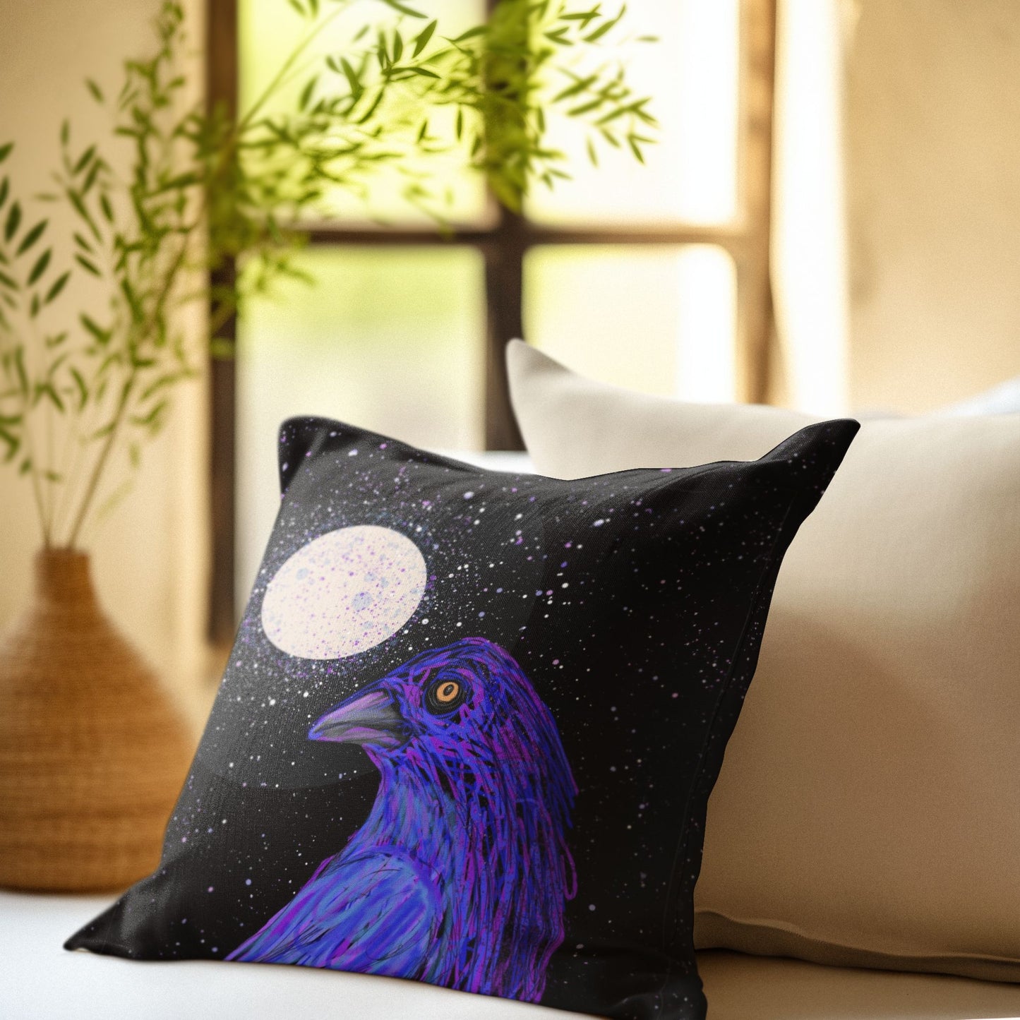 Decorative pillow with a golden-eyed crow in front of a full and moon sits in a quiet, peaceful, Zen-like room.