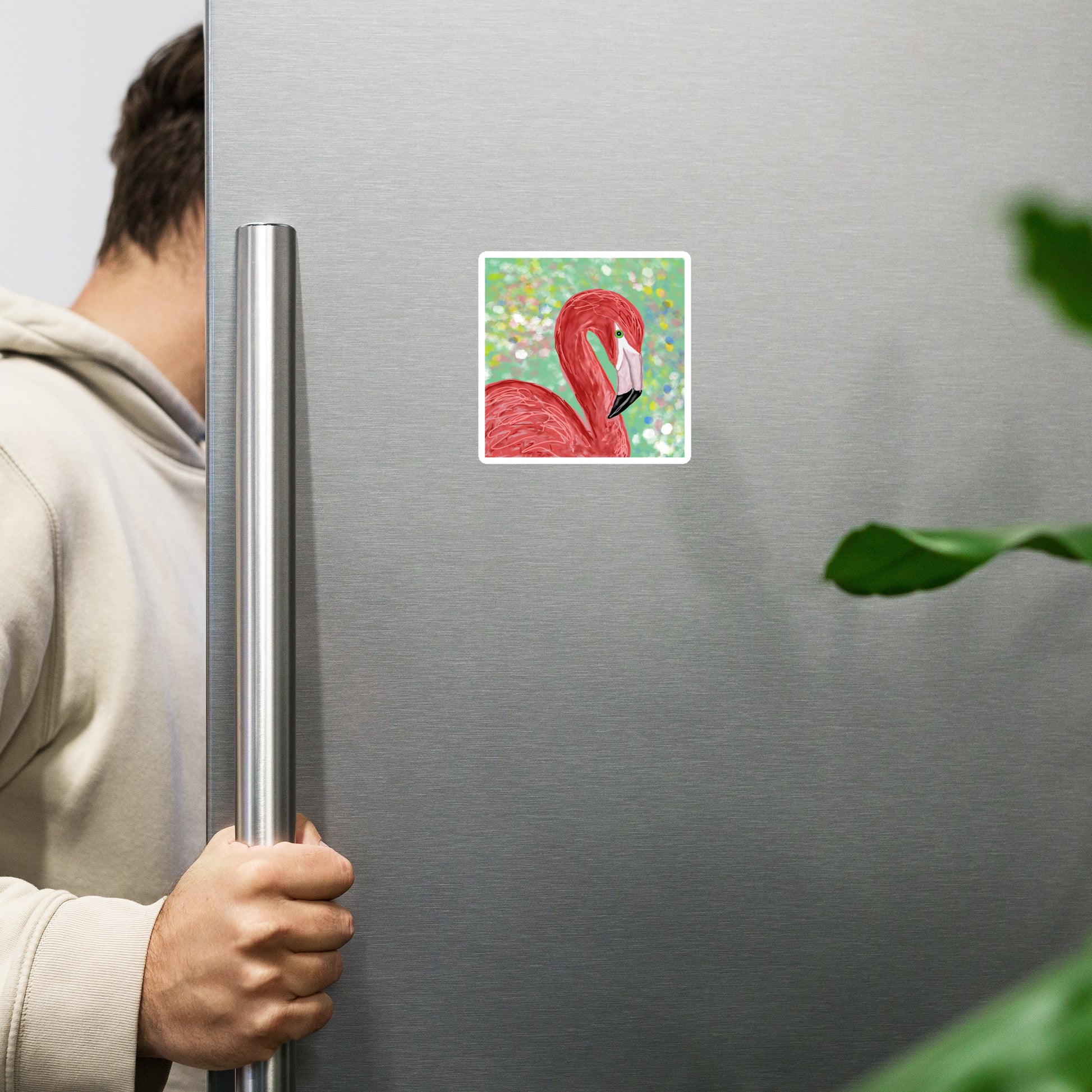 Person holding a refrigerator door with a flamingo magnet on a green background