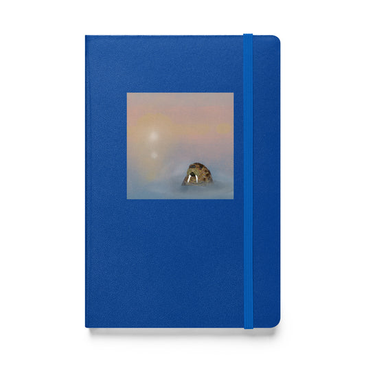 Walrus  on blue hardcover notebook/journal. Gentle giant, spirit guide, medicine man. Walrus head popping out of the misty arctic sea. Product mockup shown against white  background.