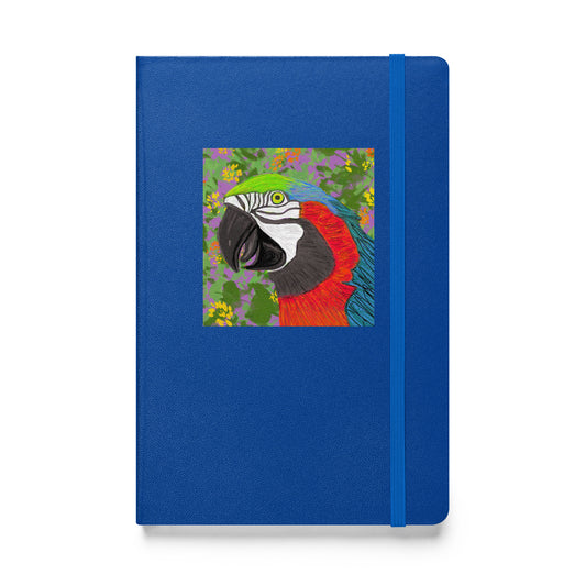 A colorful parrot original artwork on a blue journal/notebook. Journal has a ribbon bookmark and an elastic closure.