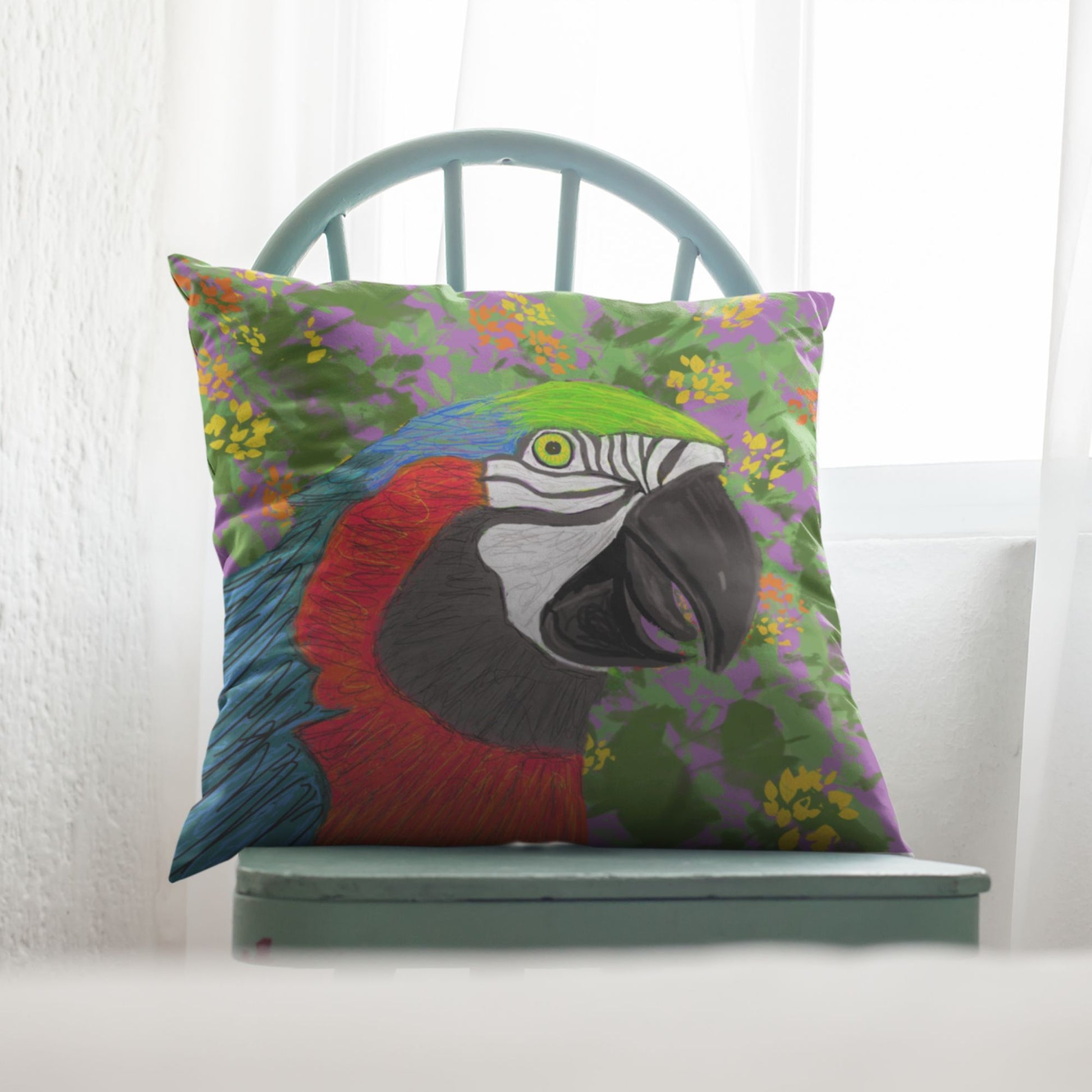 Colorful parrot pillow on a green chair with a white curtain background