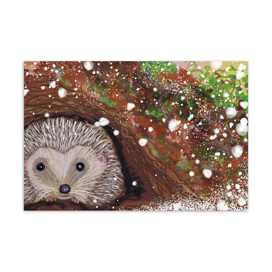 Sweet postcard with an image of the garden animal, the hedgehog.  Image shows hedgehog hibernating for the winter as it snows. Hedgehog, with his sweet face, is gentle and kind spirit animal / spirit guide connected to Mother Earth. Standard size postcard. Horizontal alignment.