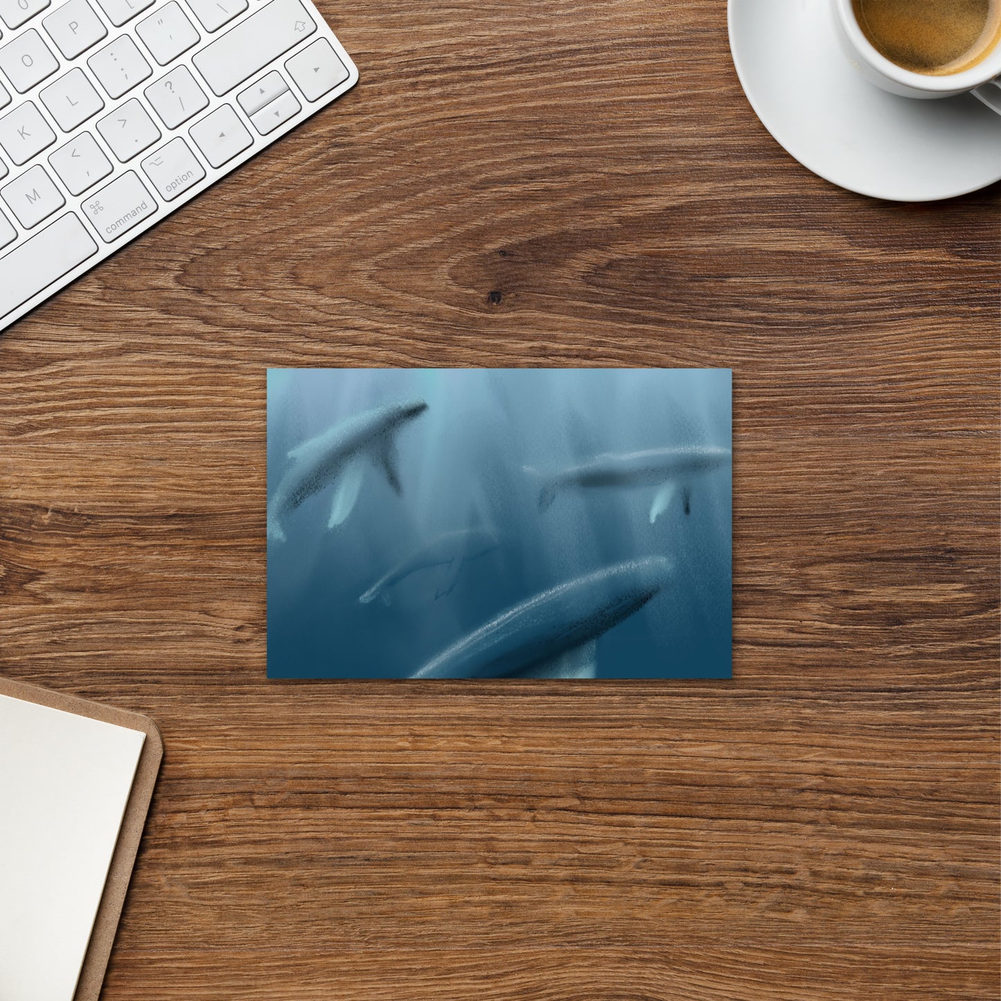 Desk with a whale postccard on a desk.
