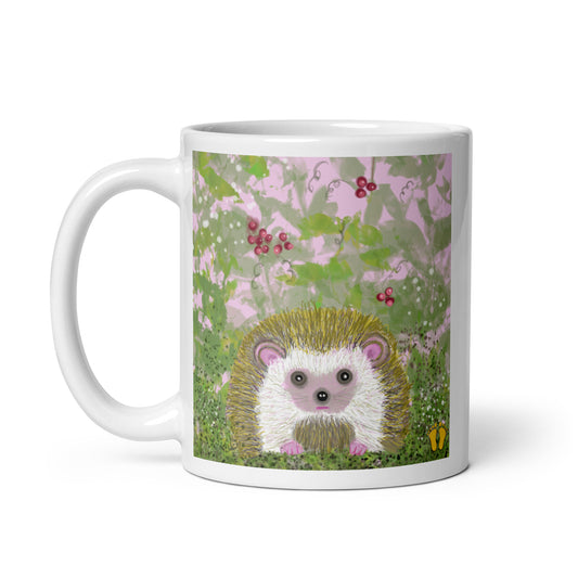 Cute hedgehog on a field of pink and green, with leaves and berries, on a white ceramic coffee mug. 11 oz. Hedgehog is gentle and kind spirit animal connected to Mother Earth.