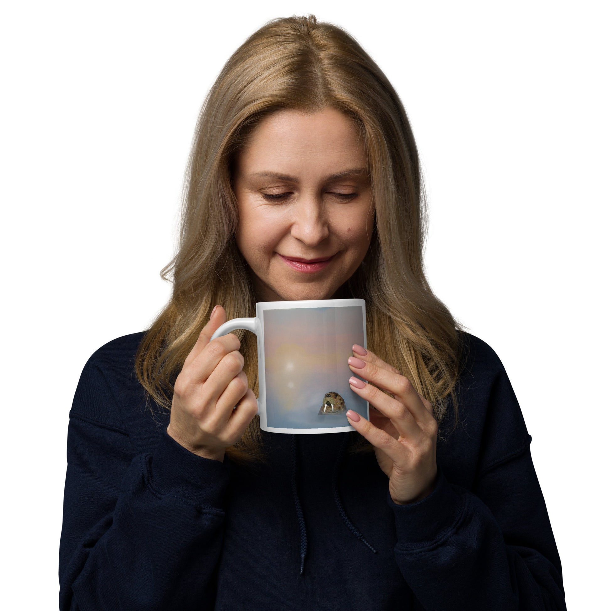 Woman holding a mug with a printed design of a walrus in the ocean on a white background