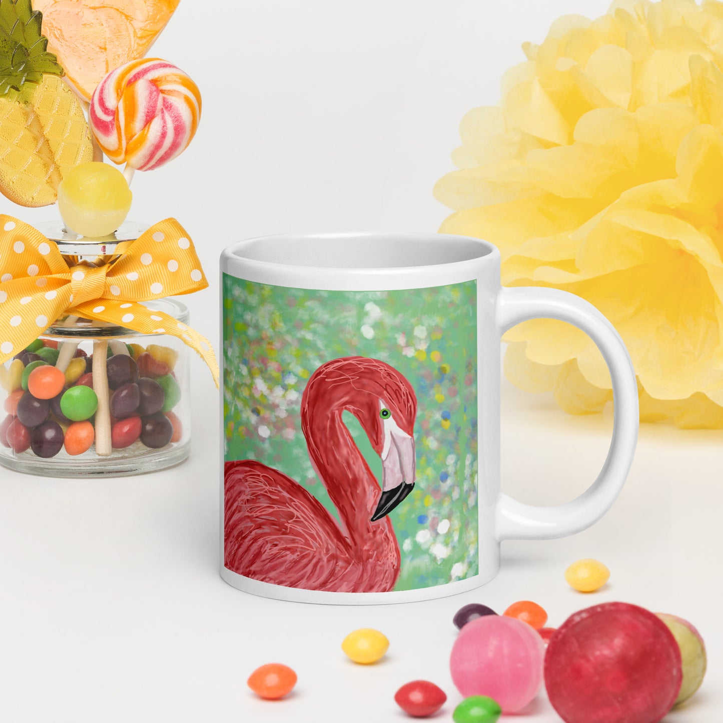 PittaPat mug with flamingo design surrounded by colorful candies and flowers