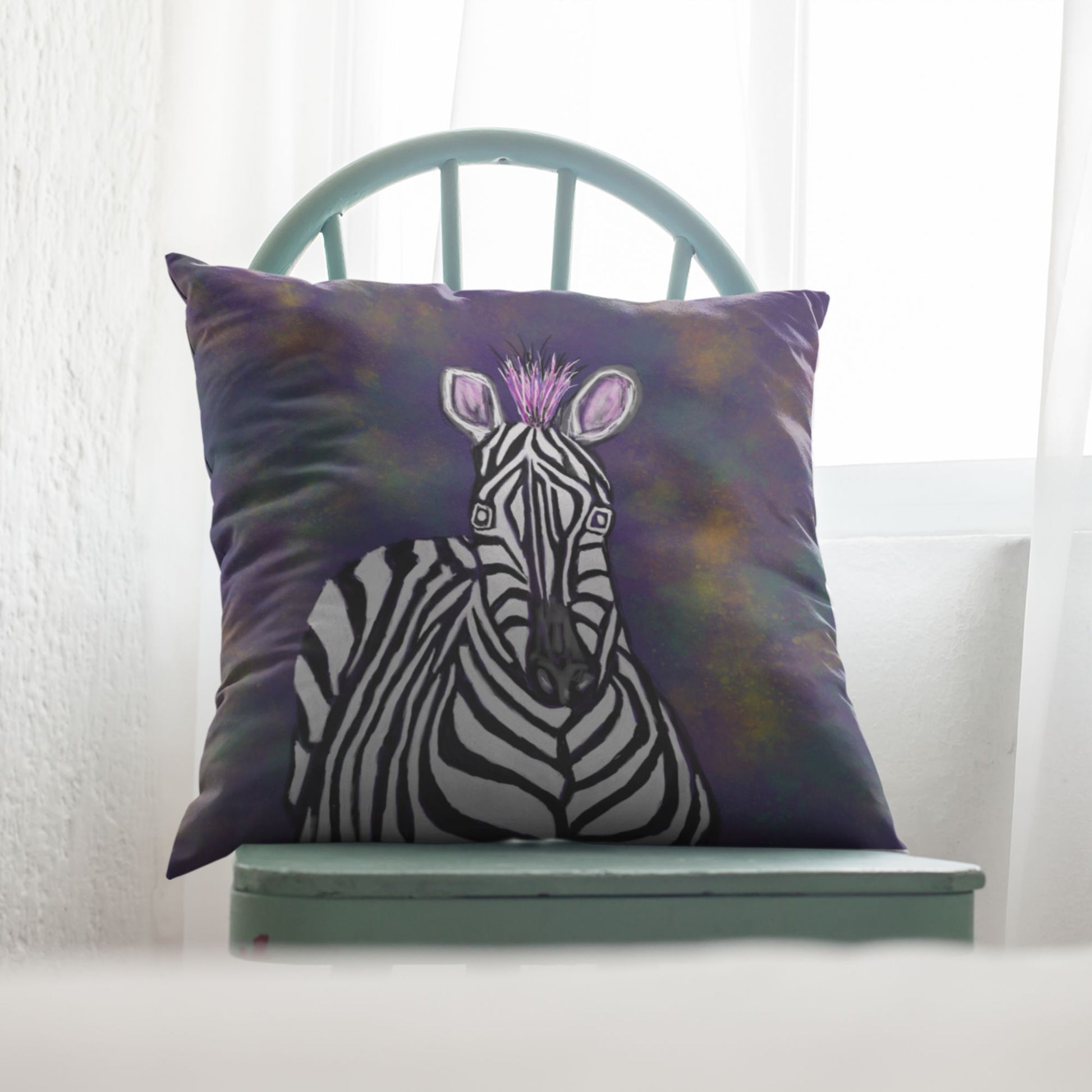 Decorative pillow with a zebra design on a green chair.