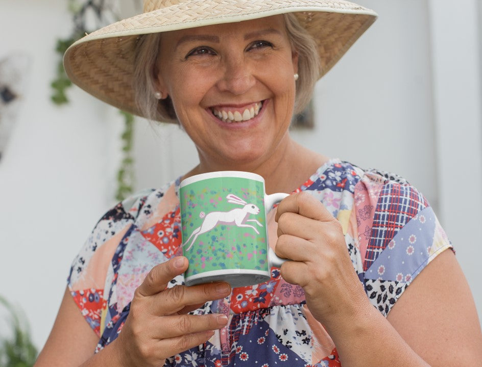 Is this March Hare by PittaPat your spirit animal? The rabbit mug is shown here being held by a smiling woman wearing a straw hat and enjoying her coffee break.