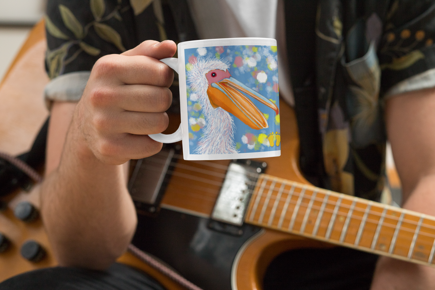 Is this joyful, laughing pelican your spirit animal? The pelican mug is shown here being held by a male musician as he takes a break.