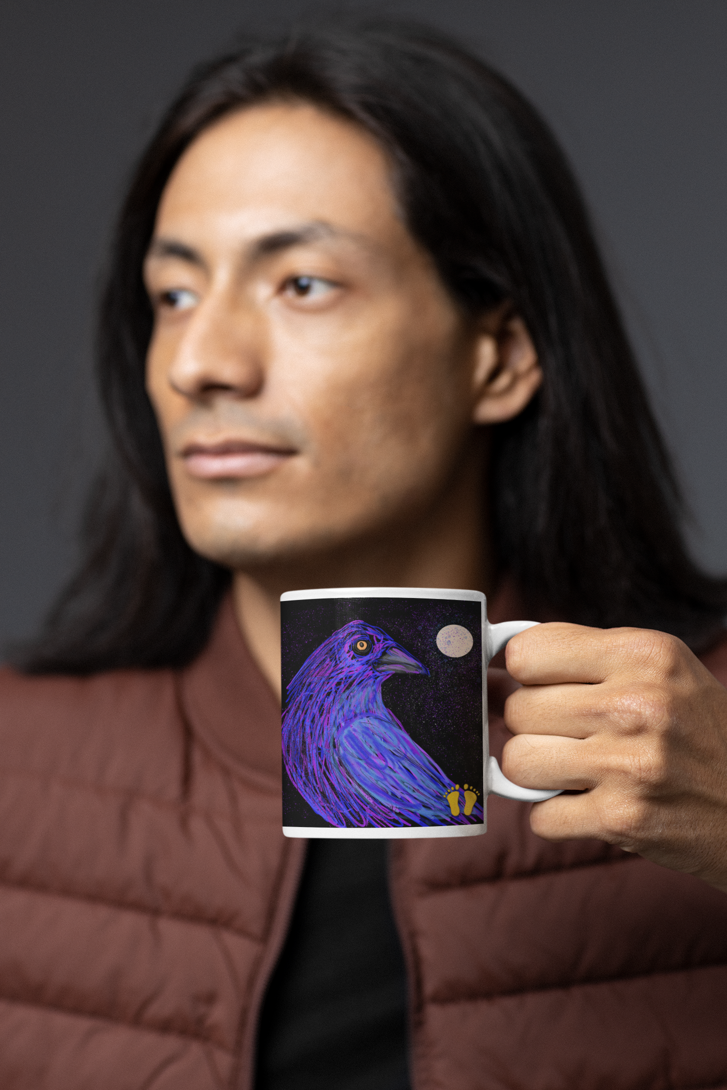 Is this crow on a mug by PittaPat your spirit animal? The crow is a sacred bird for many cultures. The 15 oz mug is held by a native man, with long black hair. Shown here with the PittaPat golden toes logo.