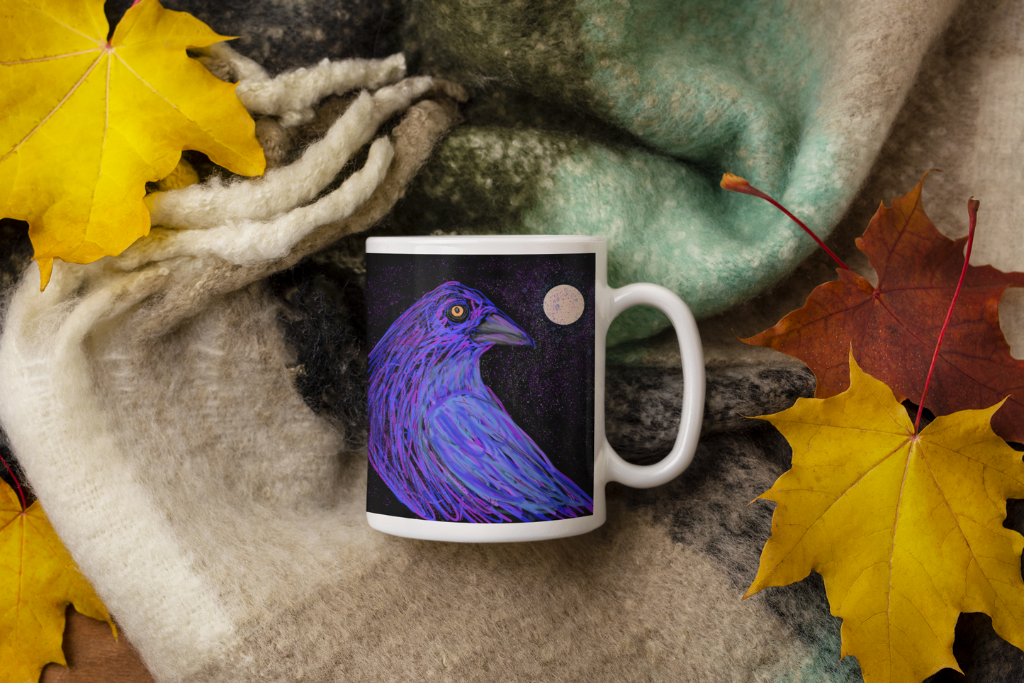 Premium ceramic coffee mug is a unique gift for bird lovers. Brightly colored chicken is on a field of yellow and blue. Shown here on a plaid fall blanket next to bright maple leaves