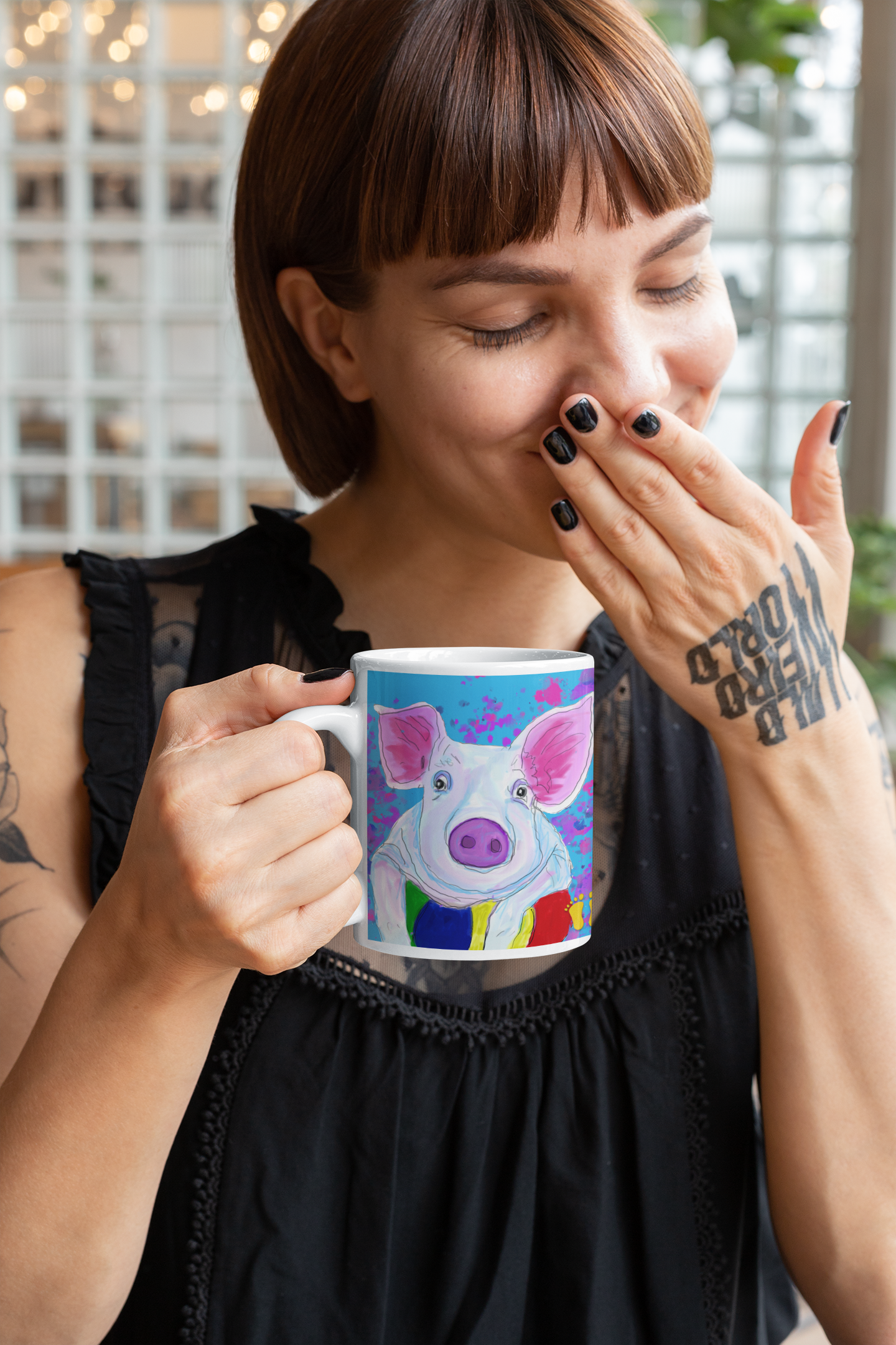 Is this pig your spirit animal? The brightly colored pig mug is shown here being held by a woman enjoying her coffee break.