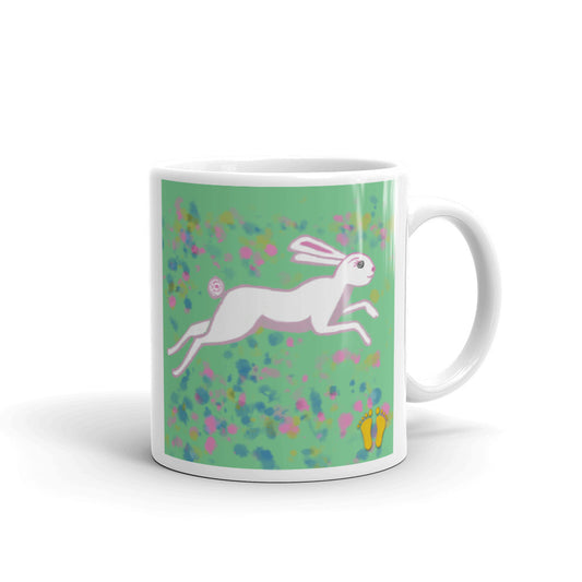 Coffee mug for March Hare and rabbit lovers. Unique  design has a  sweet expression. March Hare on field of green with pink and blue flowers. Stamped with artist's golden toes mark. 11 oz mug