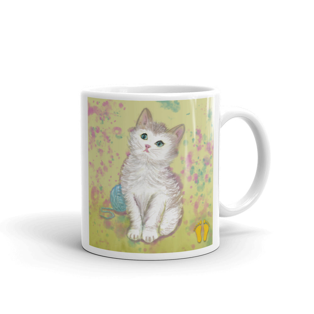 Coffee mug for kitten and cat lovers. Unique  design has a  sweet expression. Kitten on field of yellow, green and pink.  Stamped with artist's golden toes mark. 11 oz mug