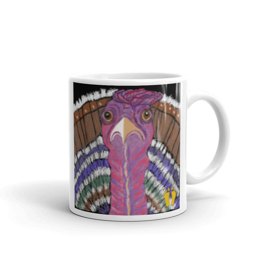 Coffee mug for turkey lovers. Unique turkey design has an astonished expression. The long neck of the turkey is shown against colorful tail feathers. Stamped with PittaPat’s golden toes mark. 11 oz mug