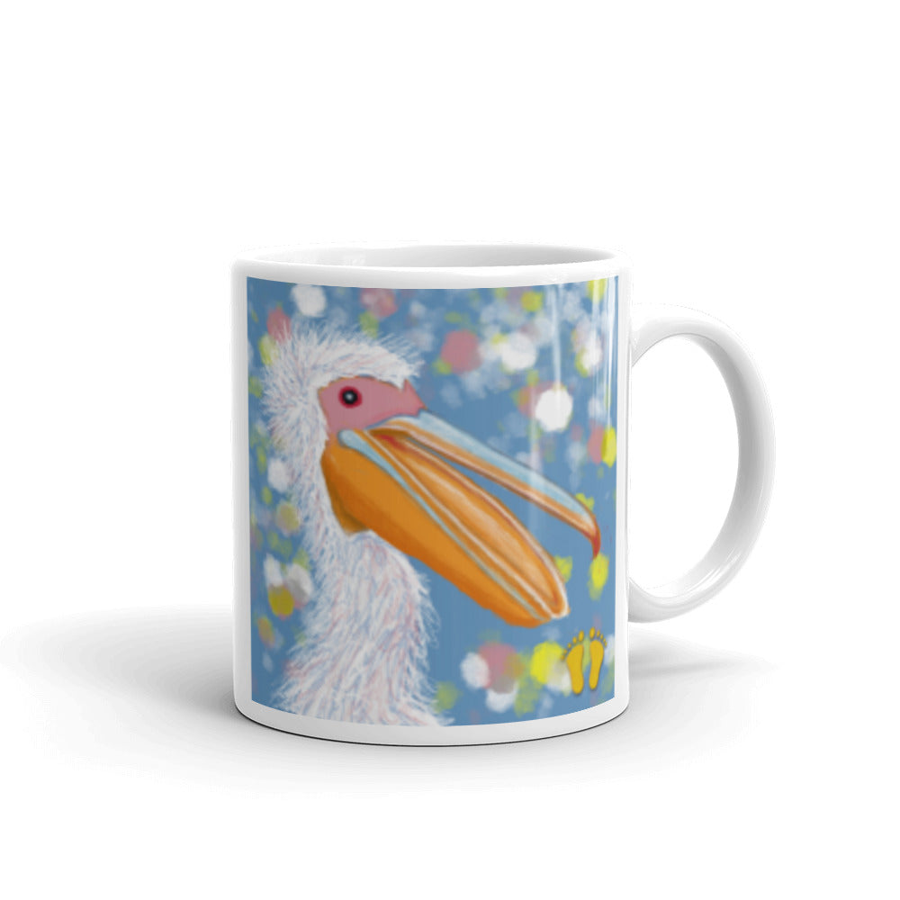  Coffee mug for pelican lovers. Joyful design with a laughing pelican and wild feathers. Pelican on field of blue with accents of pink, yellow and white. Stamped with PittaPat’s golden toes mark. 11 oz mug