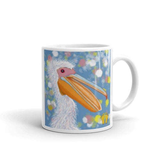  Coffee mug for pelican lovers. Joyful design with a laughing pelican and wild feathers. Pelican on field of blue with accents of pink, yellow and white. Stamped with PittaPat’s golden toes mark. 11 oz mug